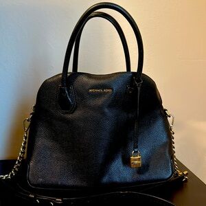 Large Michael Kors show the bag with top zipper and sides has a adjustable strap